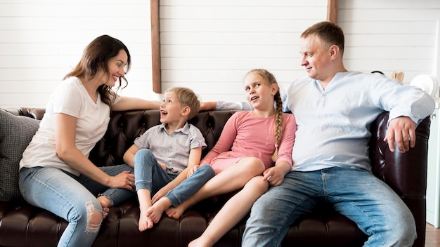 Medium shot happy family in living room