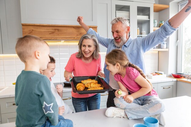 Medium shot happy family with croissants