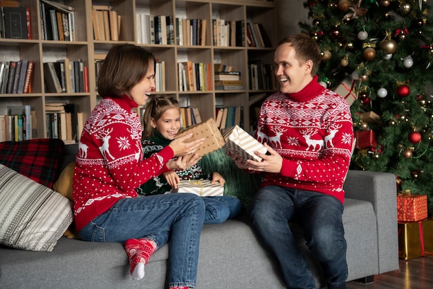 Medium shot happy family with gifts