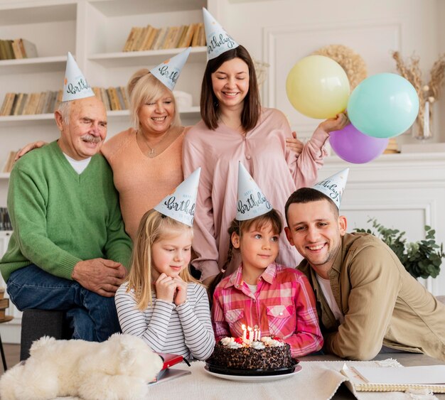 Medium shot happy family with party hats