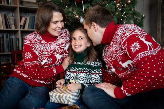 Free photo medium shot happy family with present