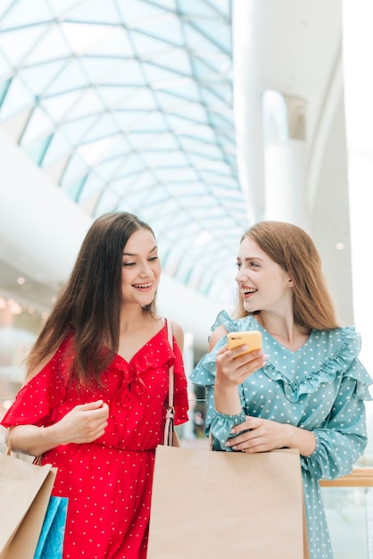 Medium shot happy friends at shopping mall