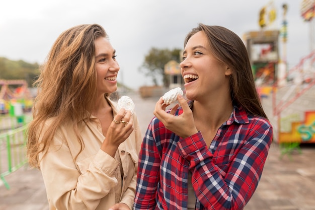 Medium shot happy friends with sweets