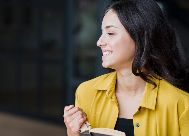 Medium shot happy girl with book