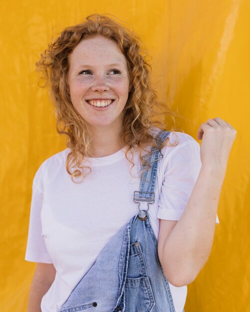 Medium shot happy girl with yellow background