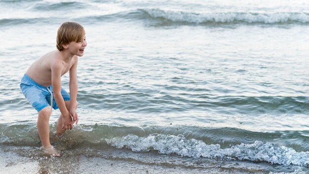 Medium shot happy kid at seaside