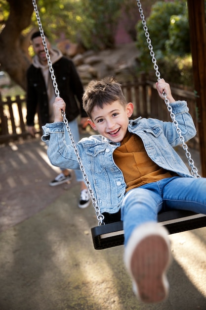 Medium shot happy kid on swing