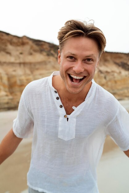 medium shot happy man at beach
