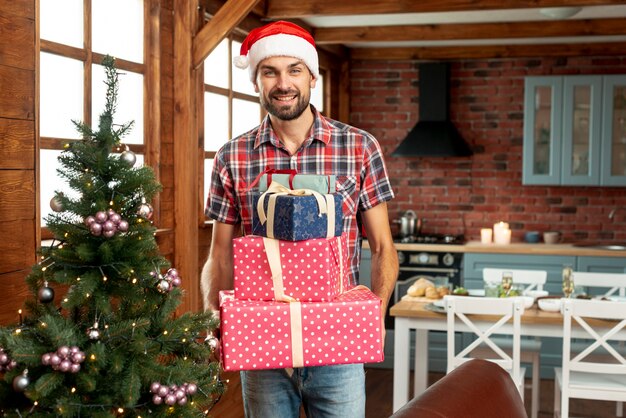 Medium shot happy man holding gifts