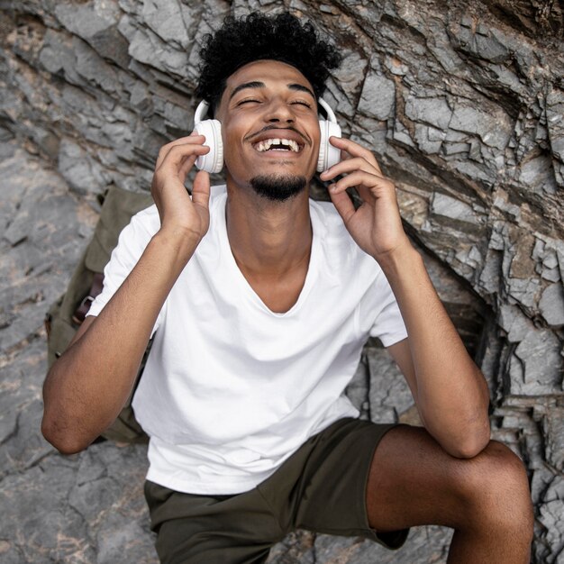 Medium shot happy man wearing headphones