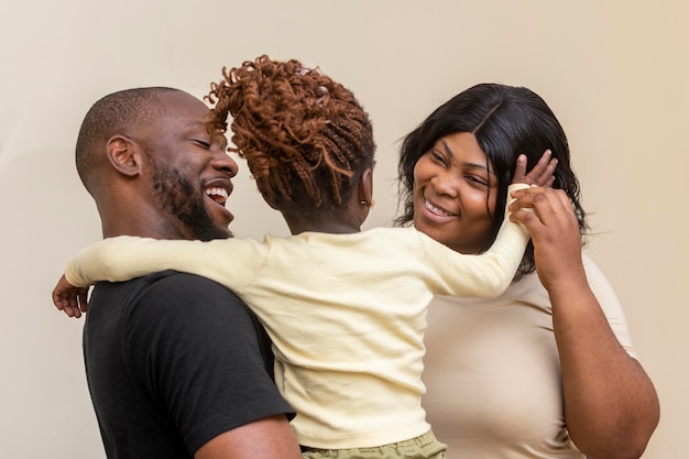 Medium shot happy parents and girl