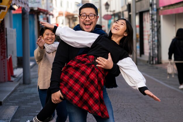 Medium shot happy parents and girl