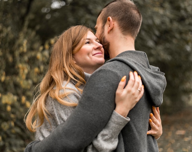 Medium shot happy partners hugging