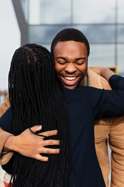 Medium shot happy partners hugging