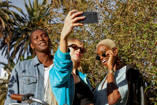 Medium shot happy people taking selfie