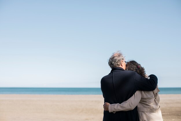 Medium shot happy senior people at beach