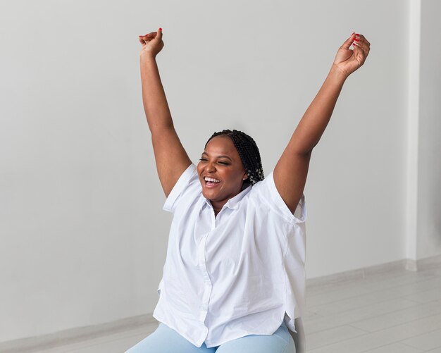 Medium shot happy woman on chair