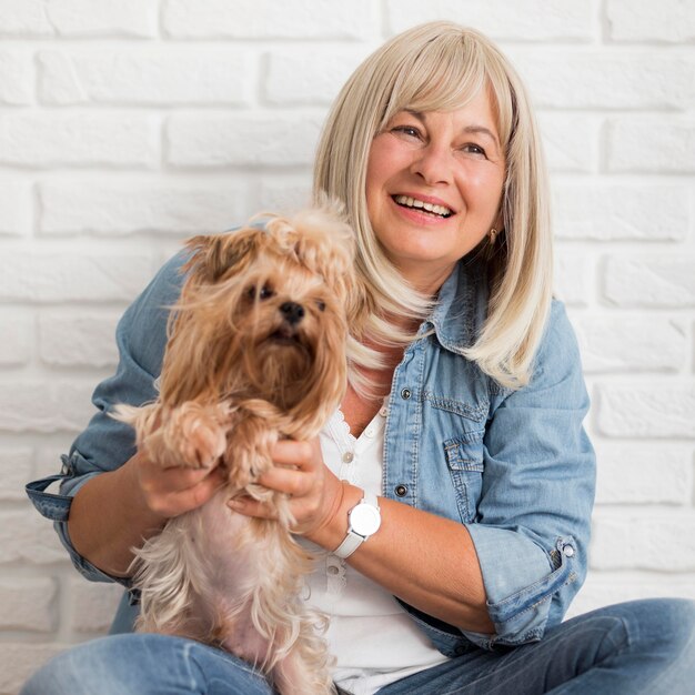 Medium shot happy woman holding dog