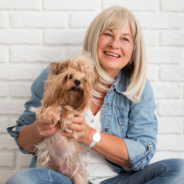 Medium shot happy woman holding dog