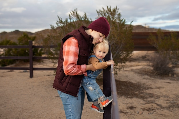 Medium shot happy woman holding kid