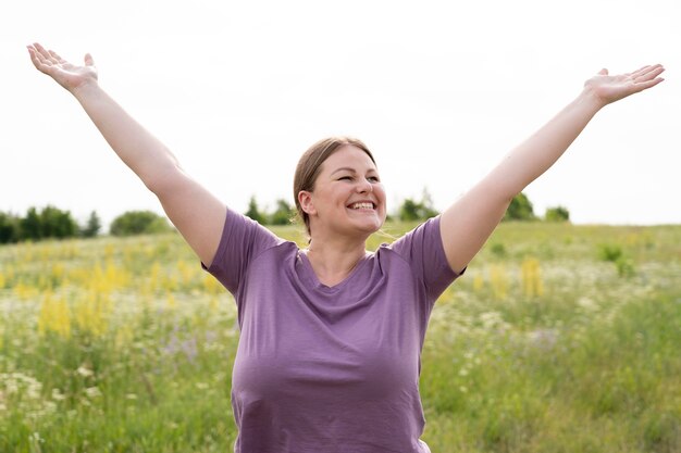 Medium shot happy woman in nature