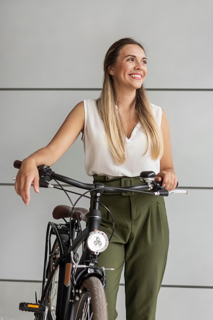 Medium shot happy woman with bike