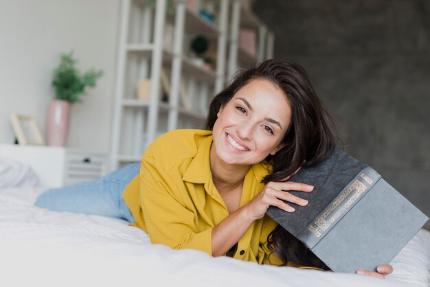 Medium shot happy woman with book