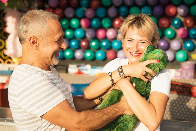 Medium shot happy woman with dinosaur toy