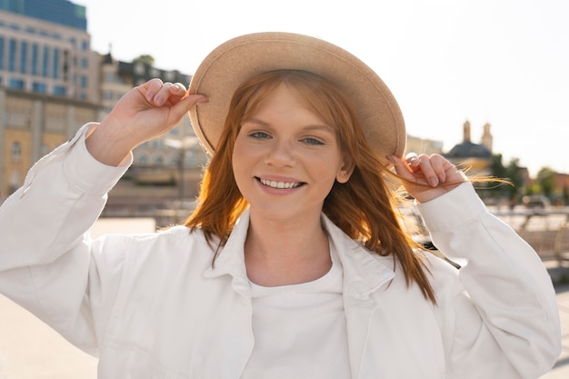 Free photo medium shot happy woman with hat