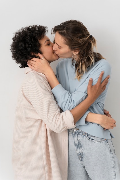 Free photo medium shot happy women kissing