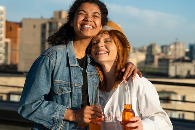 Free photo medium shot happy women with bottles