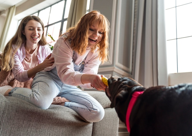 Средний снимок счастливых женщин с собакой