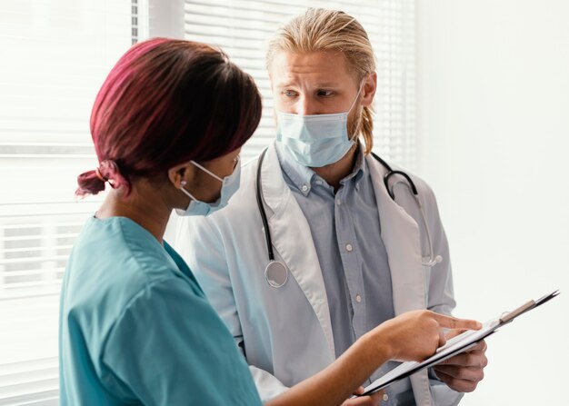 Medium shot health workers with mask