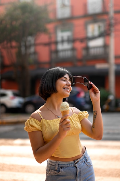 Medium shot hispanic woman holding ice cream