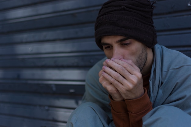 Medium shot of homeless man being cold