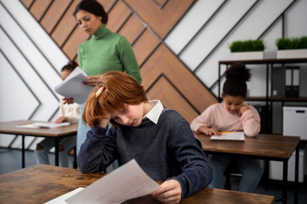 Medium shot kid cheating at school test