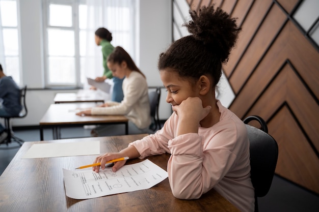 Medium shot kid cheating at school test