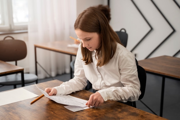 Free photo medium shot kid cheating at school test