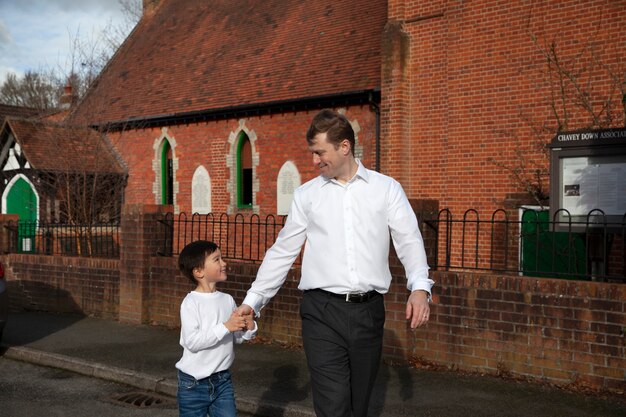 Medium shot kid and father walking together