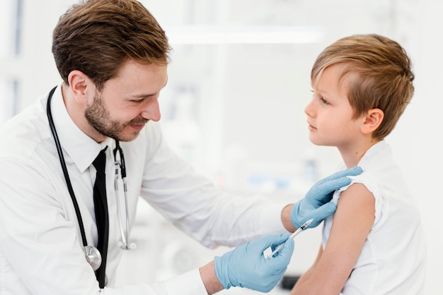 Medium shot kid getting vaccinated