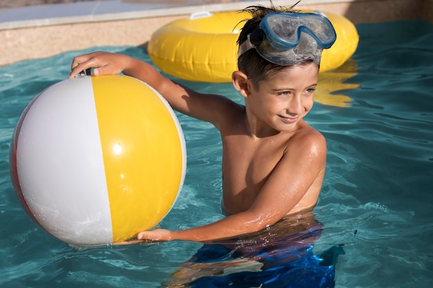 Free photo medium shot kid holding ball