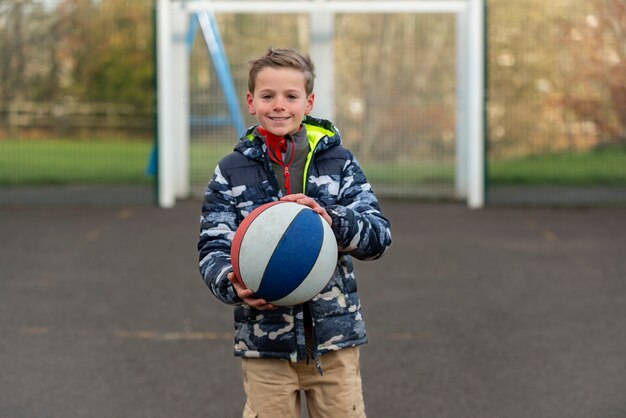 Medium shot kid holding ball