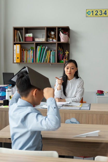 Medium shot kid holding book over head