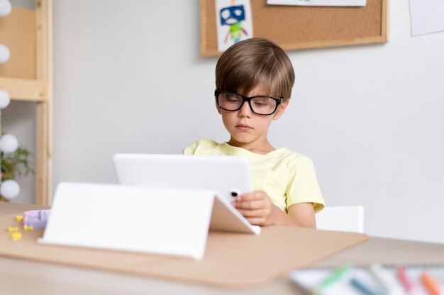 Medium shot kid holding tablet