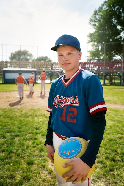 Medium shot kid holding yellow ball