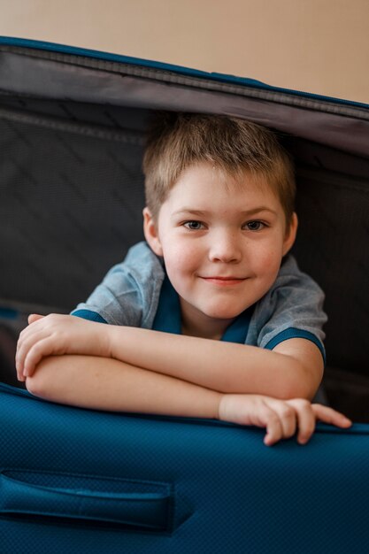 Medium shot kid laying in luggage