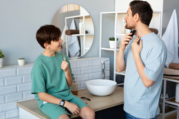 Medium shot kid learning how to shave