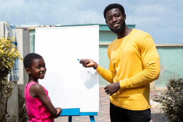 Medium shot kid and man with board