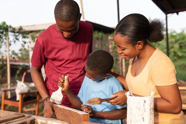 Free photo medium shot kid painting wood