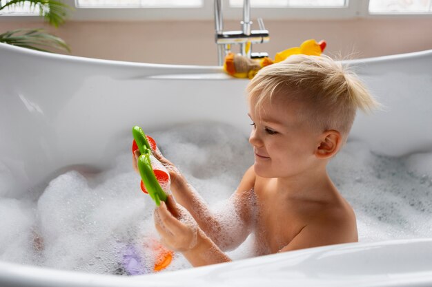 Medium shot kid playing in bathtub